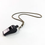 Black plastic whistle with cord on white background