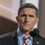 Mike Flynn standing before microphone