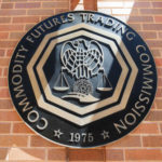 Cast metal seal of CFTC on brick wall
