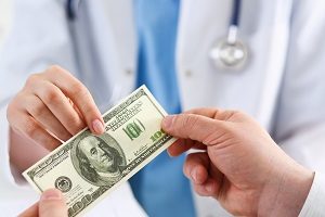 Doctor Hand Taking Money from Patient's Hand