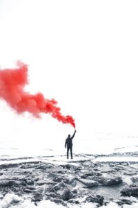 man with red smoke