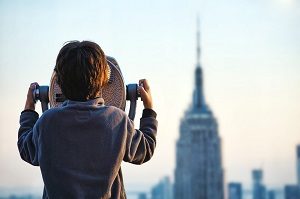 Child Looking Through Telescope of New York Building