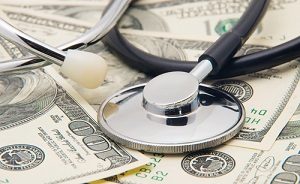 stethoscope on top of money and coins