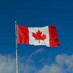 canadian flag with sky in the background