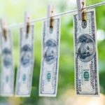hundred dollar bills hanging from clothes line