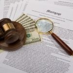 mortgage papers with gavel, cash and magnifying glass