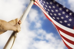 person raising the U.S. flag