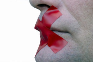 red tape over person mouth
