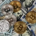 Cryptocurrency and US Hundred Dollar Bills Scattered Around