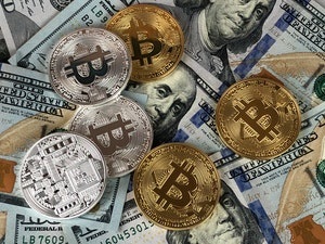 Cryptocurrency and US Hundred Dollar Bills Scattered Around