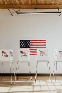 United States Flag with Voting Desks in Front
