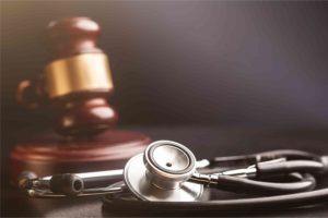 Healthcare fraud image showing stethoscope with gavel
