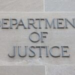 "Department of Justice" plaque on stone wall